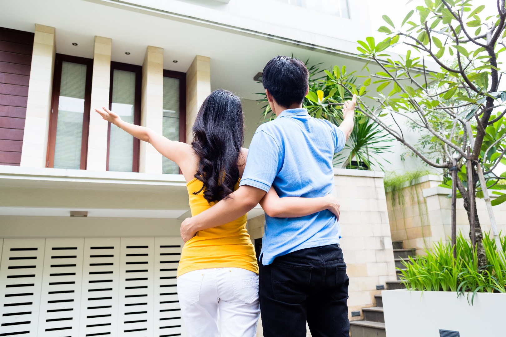 Man shows his woman their new Asian house